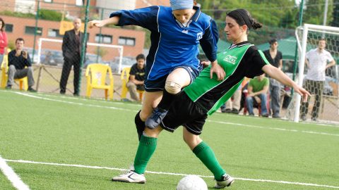 two female students on the field during a soccer match